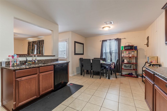 kitchen with light tile patterned flooring, a sink, plenty of natural light, visible vents, and black appliances