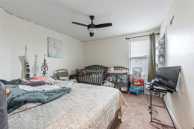 bedroom with baseboards, ceiling fan, and carpet