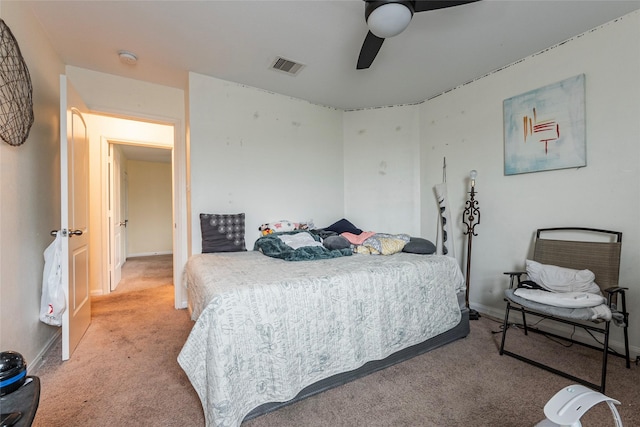 carpeted bedroom featuring baseboards, ceiling fan, and visible vents