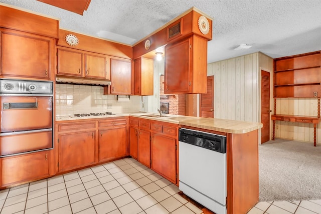 2509 Bayou Ave, Baytown, TX 77520 - kitchen featuring white appliances, a warming drawer, tile countertops, a textured ceiling, and brown cabinets