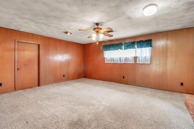 2509 Bayou Ave, Baytown, TX 77520 - carpeted empty room with a ceiling fan and wooden walls