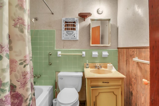 2509 Bayou Ave, Baytown, TX 77520 - bathroom with shower / tub combo with curtain, vanity, toilet, wainscoting, and tile walls