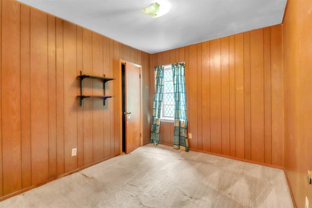 2509 Bayou Ave, Baytown, TX 77520 - carpeted empty room featuring wooden walls and baseboards