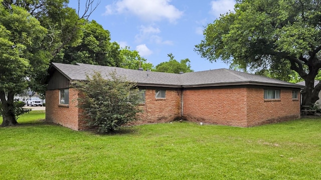 2509 Bayou Ave, Baytown, TX 77520 - view of property exterior with a yard, brick siding, and a shingled roof