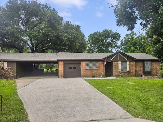 2509 Bayou Ave, Baytown, TX 77520 - view of front of home featuring asphalt driveway, a front yard, an attached carport, a garage, and brick siding