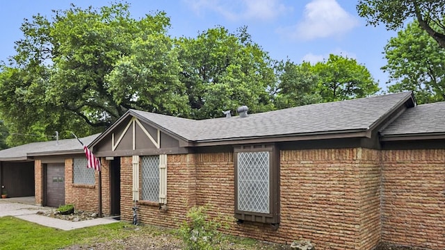 2509 Bayou Ave, Baytown, TX 77520 - view of front of home with an attached garage, driveway, roof with shingles, and brick siding