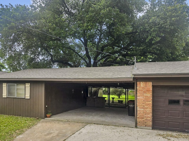 2509 Bayou Ave, Baytown, TX 77520 - garage featuring a carport and driveway