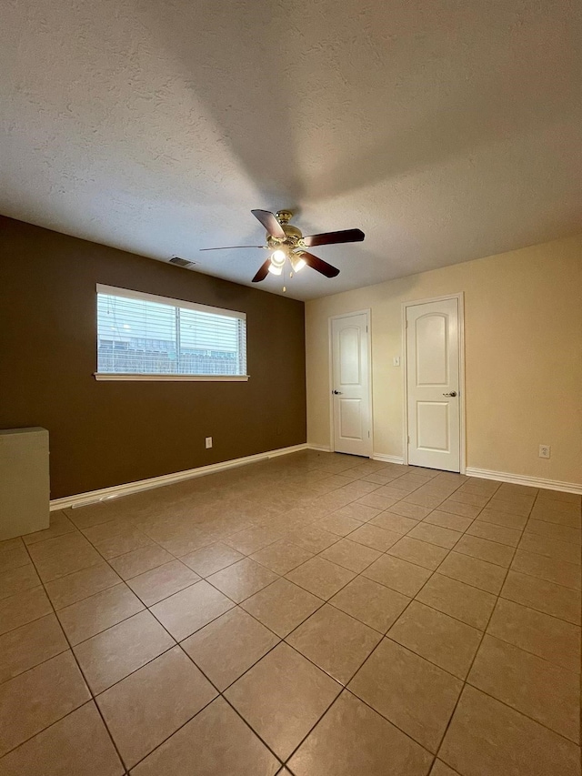 2503 Radcliffe Dr, Sugar Land, TX 77498 - spare room with light tile patterned flooring, ceiling fan, and a textured ceiling