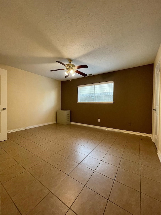 2503 Radcliffe Dr, Sugar Land, TX 77498 - spare room featuring light tile patterned floors, ceiling fan, and a textured ceiling