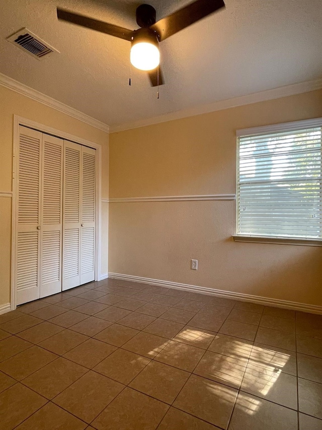 2503 Radcliffe Dr, Sugar Land, TX 77498 - unfurnished bedroom with crown molding, tile patterned floors, a closet, and ceiling fan