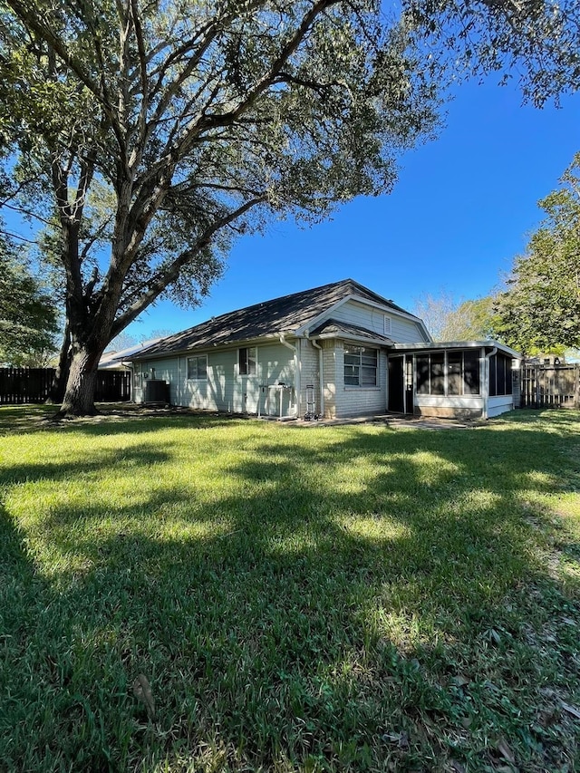 2503 Radcliffe Dr, Sugar Land, TX 77498 - rear view of property with a sunroom