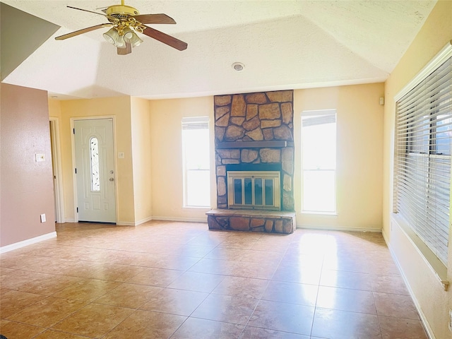 2503 Radcliffe Dr, Sugar Land, TX 77498 - unfurnished living room featuring a ceiling fan, tile patterned flooring, a textured ceiling, and a fireplace