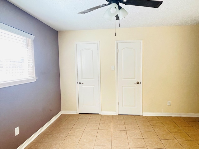2503 Radcliffe Dr, Sugar Land, TX 77498 - spare room featuring ceiling fan, light tile patterned flooring, and a textured ceiling
