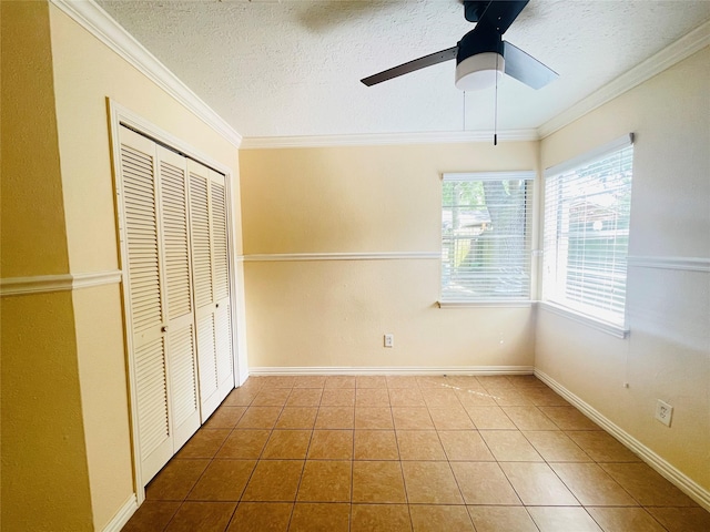 2503 Radcliffe Dr, Sugar Land, TX 77498 - unfurnished bedroom with tile patterned flooring, crown molding, a closet, a textured ceiling, and a ceiling fan