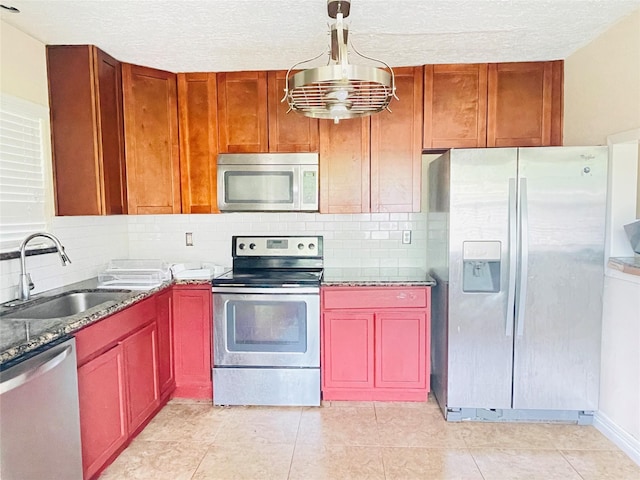 2503 Radcliffe Dr, Sugar Land, TX 77498 - kitchen with stainless steel appliances, tasteful backsplash, stone counters, light tile patterned floors, and a textured ceiling