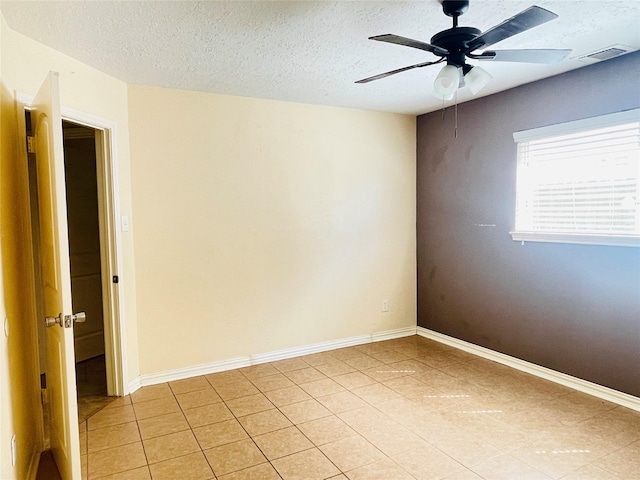 2503 Radcliffe Dr, Sugar Land, TX 77498 - spare room with ceiling fan, light tile patterned flooring, and a textured ceiling