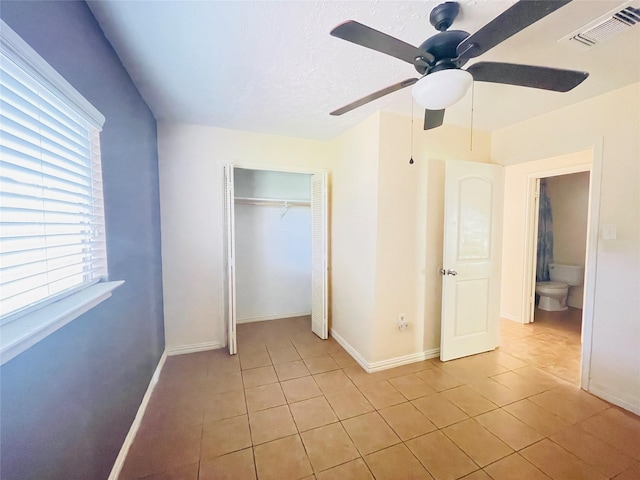 2503 Radcliffe Dr, Sugar Land, TX 77498 - unfurnished bedroom featuring light tile patterned flooring, a closet, and a ceiling fan