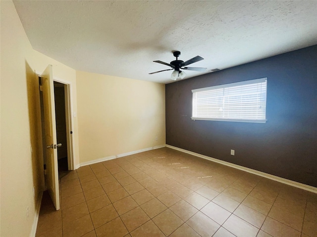 2503 Radcliffe Dr, Sugar Land, TX 77498 - unfurnished room with tile patterned flooring, a ceiling fan, and a textured ceiling