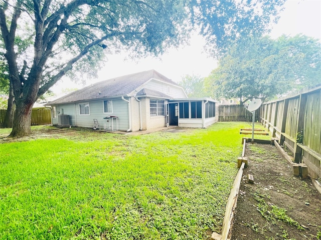 2503 Radcliffe Dr, Sugar Land, TX 77498 - rear view of house with a sunroom, a fenced backyard, and a garden