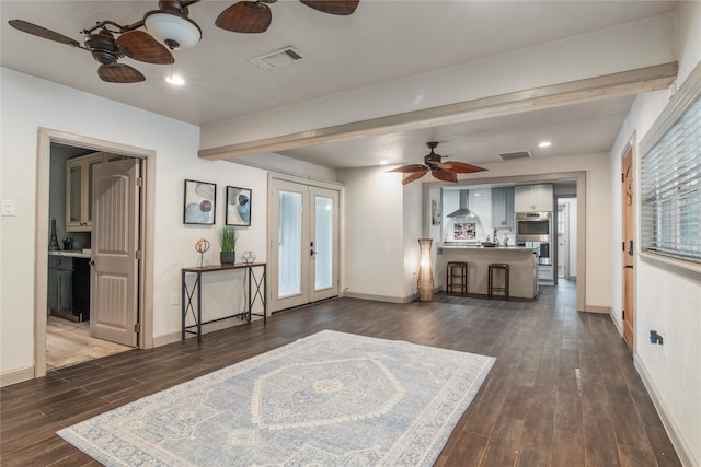 living area with ceiling fan, visible vents, baseboards, french doors, and wood finished floors