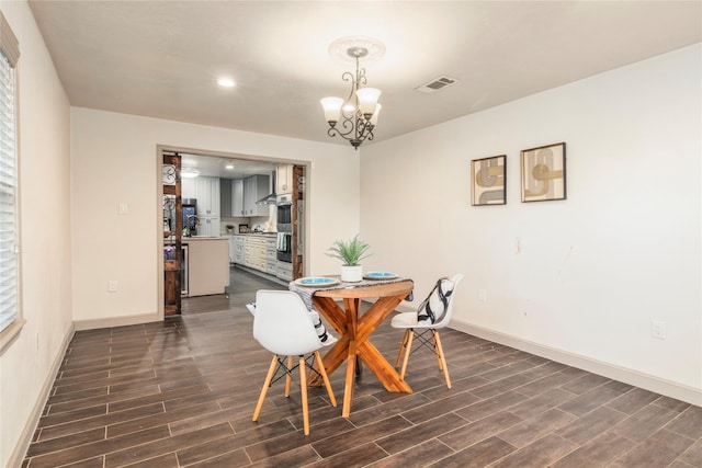 dining area featuring baseboards, visible vents, and dark wood-style flooring