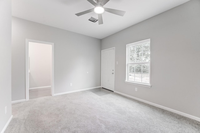 spare room with baseboards, carpet floors, and ceiling fan