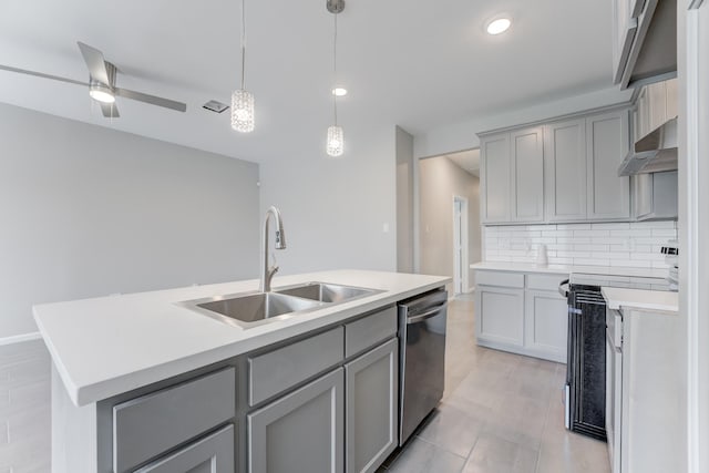 kitchen with stainless steel dishwasher, gray cabinetry, wall chimney exhaust hood, and a sink