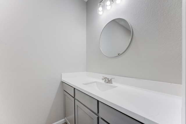 bathroom with vanity and baseboards