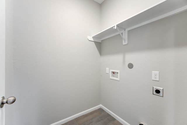 laundry area with hookup for a washing machine, hookup for an electric dryer, laundry area, baseboards, and gas dryer hookup