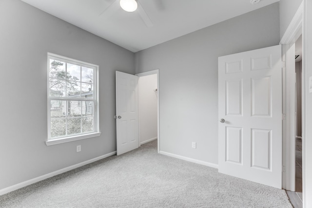 unfurnished bedroom featuring baseboards, carpet floors, and ceiling fan