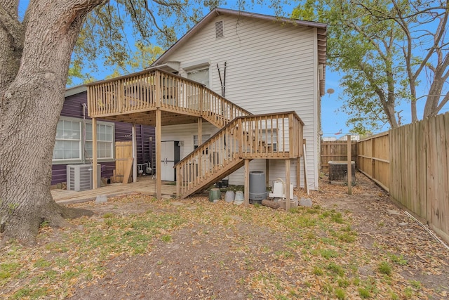 back of house featuring cooling unit, stairs, a fenced backyard, and a deck