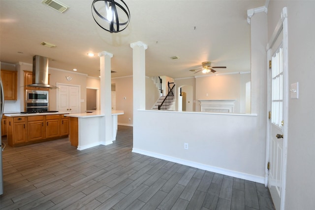 18719 Racquet Sports Way, Humble, TX 77346 - kitchen with island exhaust hood, stainless steel microwave, open floor plan, ceiling fan, and ornamental molding
