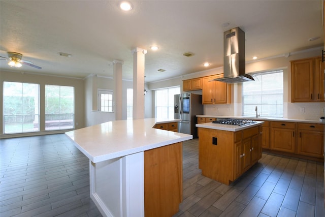 18719 Racquet Sports Way, Humble, TX 77346 - kitchen with island exhaust hood, appliances with stainless steel finishes, a kitchen island, ornamental molding, and ceiling fan