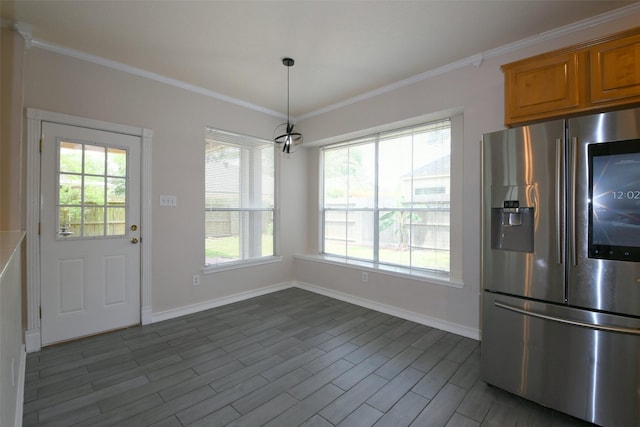 18719 Racquet Sports Way, Humble, TX 77346 - kitchen with stainless steel fridge, baseboards, ornamental molding, brown cabinetry, and decorative light fixtures