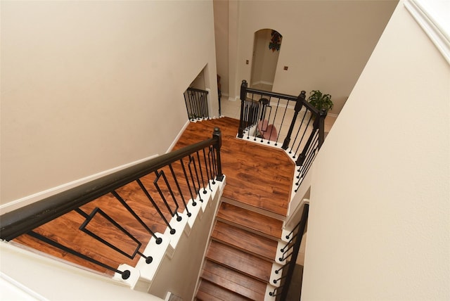 18719 Racquet Sports Way, Humble, TX 77346 - stairs featuring arched walkways, wood finished floors, and baseboards