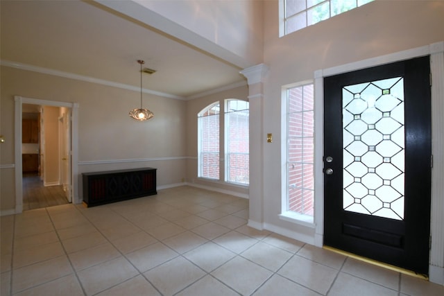 18719 Racquet Sports Way, Humble, TX 77346 - foyer entrance featuring crown molding, light tile patterned flooring, healthy amount of natural light, ornate columns, and baseboards
