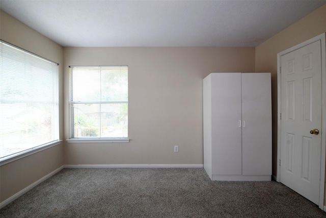 18719 Racquet Sports Way, Humble, TX 77346 - unfurnished bedroom with carpet flooring and baseboards