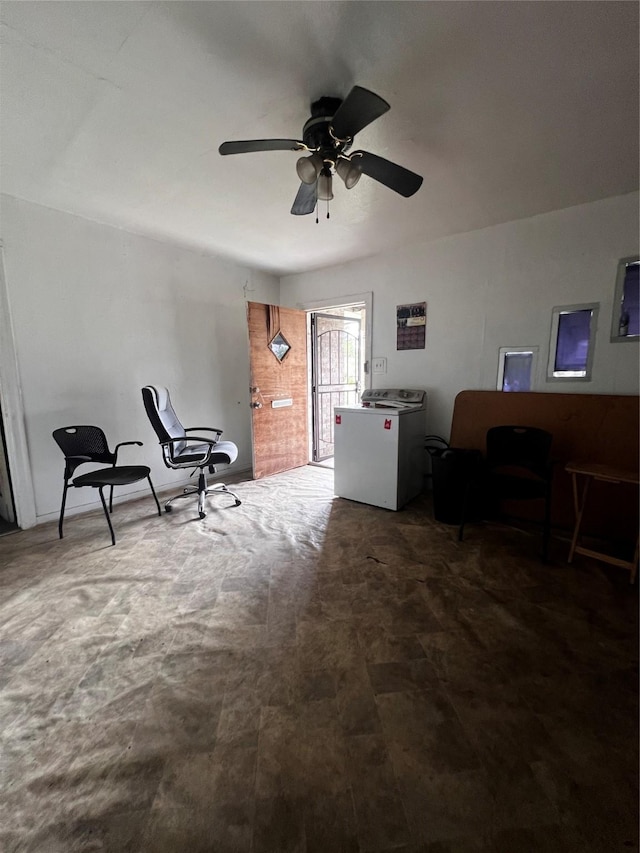 sitting room with washer / clothes dryer and a ceiling fan