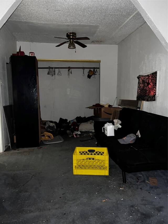 unfurnished living room with unfinished concrete floors, a textured ceiling, and ceiling fan