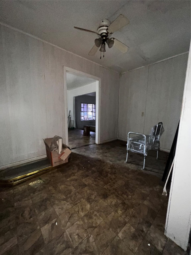spare room with tile patterned floors and a ceiling fan