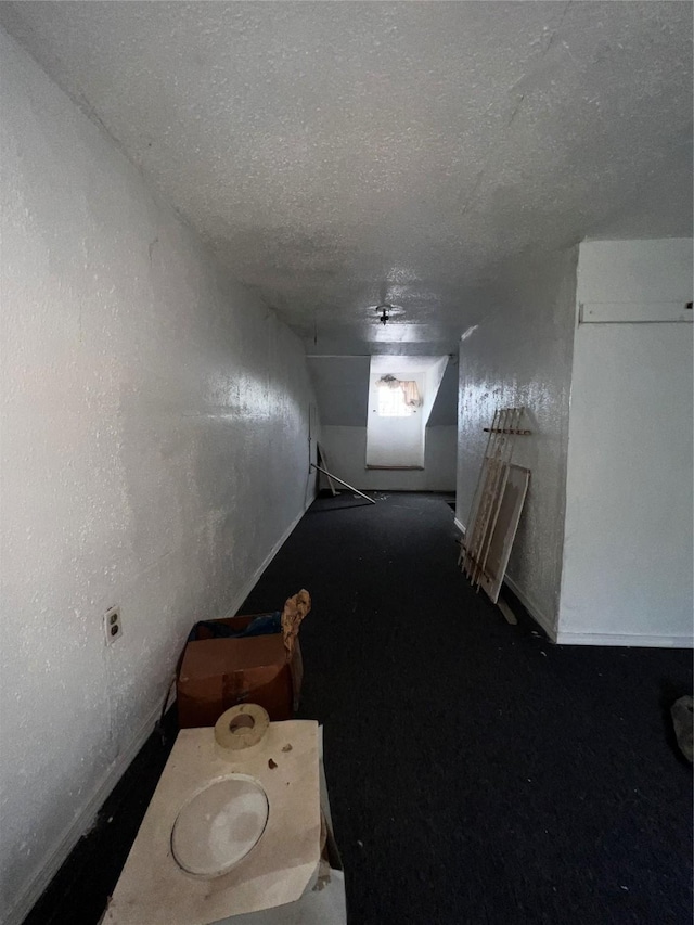 hallway featuring a textured ceiling