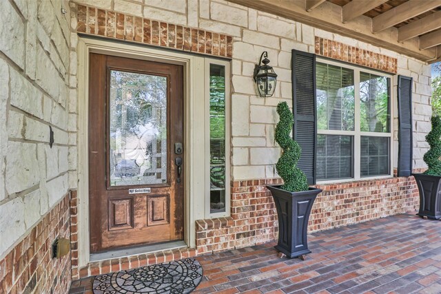 24143 Auburn Woods Ct, Porter, TX 77365 - entrance to property with stone siding, a porch, and brick siding