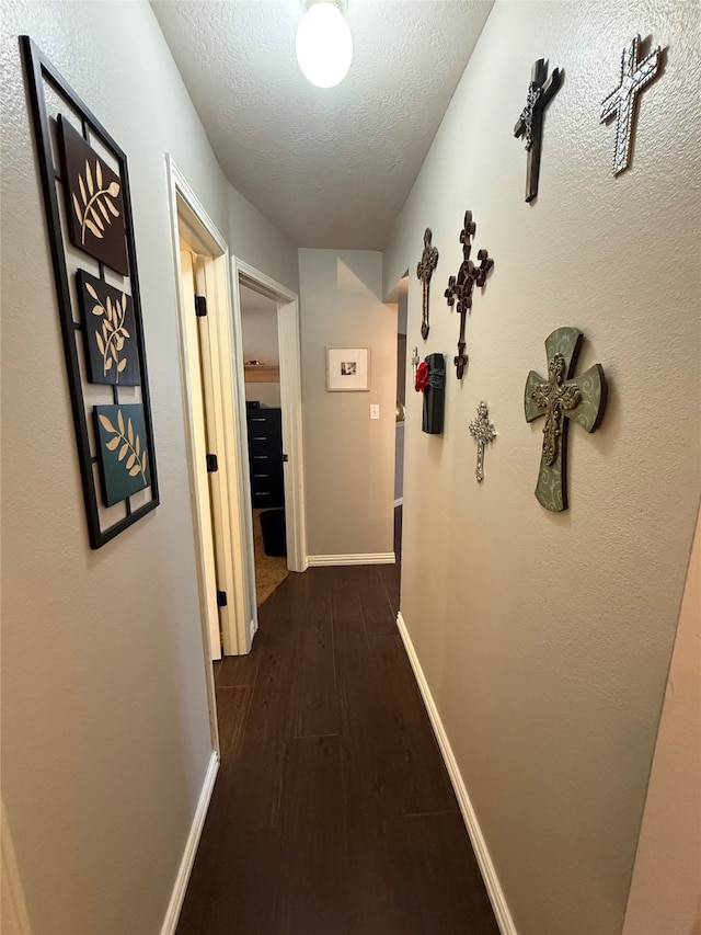 9319 Dalmore Ct, Houston, TX 77095 - corridor with baseboards, dark wood-type flooring, and a textured ceiling