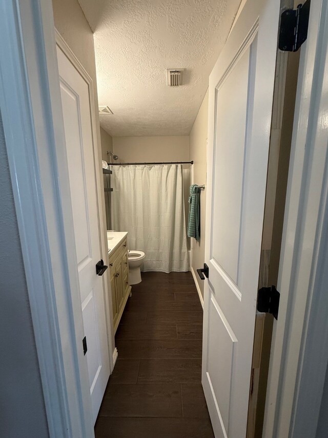 9319 Dalmore Ct, Houston, TX 77095 - full bath with visible vents, toilet, wood finished floors, curtained shower, and vanity