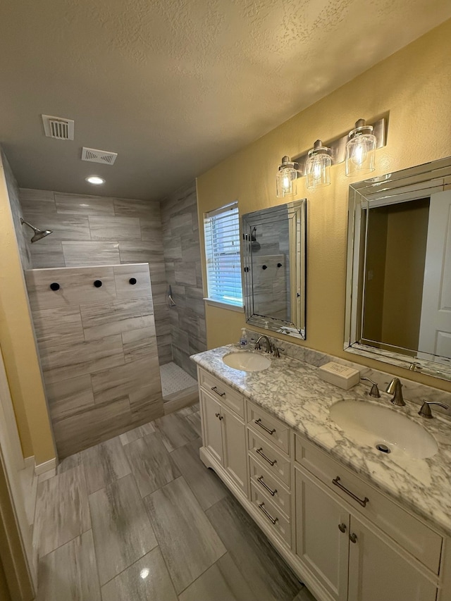 9319 Dalmore Ct, Houston, TX 77095 - bathroom with visible vents, a walk in shower, and a sink