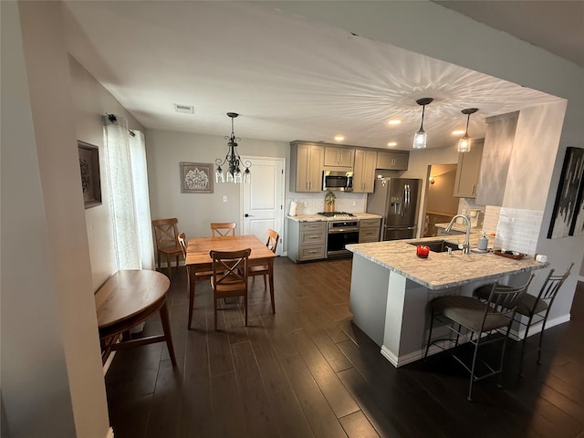 9319 Dalmore Ct, Houston, TX 77095 - kitchen with a sink, stainless steel appliances, gray cabinets, and dark wood finished floors