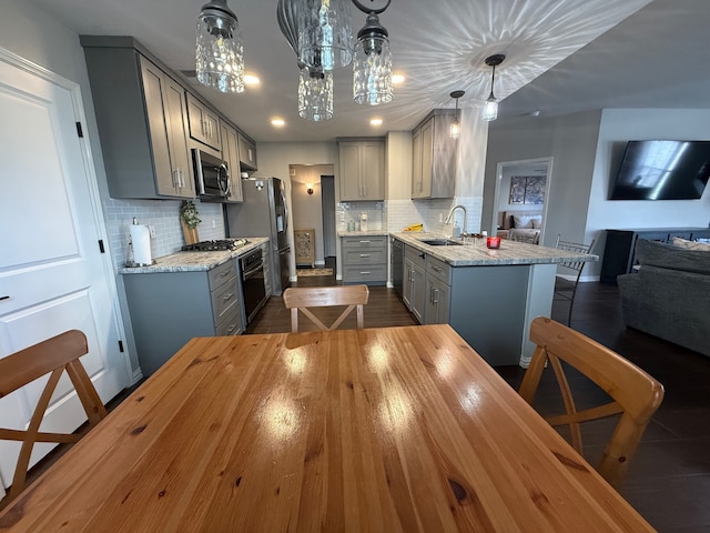 9319 Dalmore Ct, Houston, TX 77095 - kitchen with gray cabinetry, open floor plan, a sink, and stainless steel appliances