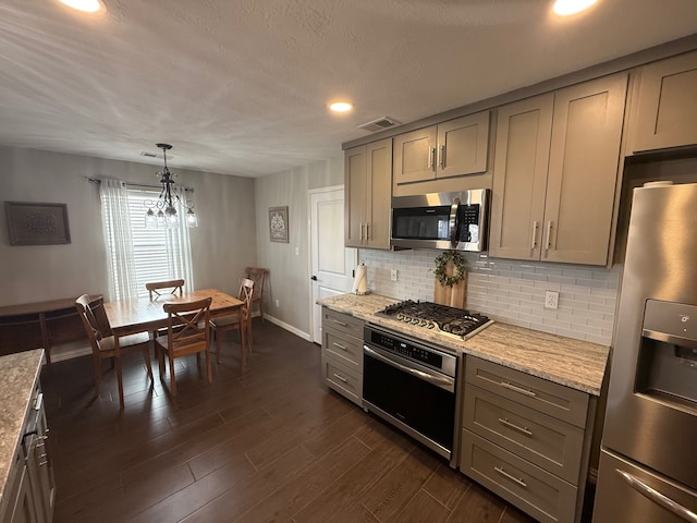 9319 Dalmore Ct, Houston, TX 77095 - kitchen with gray cabinets, dark wood-style flooring, decorative backsplash, and stainless steel appliances