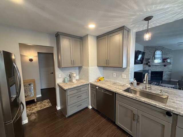 9319 Dalmore Ct, Houston, TX 77095 - kitchen featuring decorative backsplash, stainless steel appliances, a sink, gray cabinetry, and dark wood-style floors