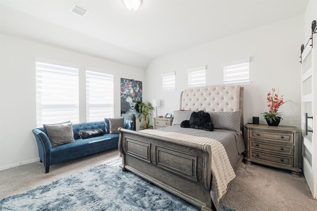 31511 Kailua Dr, Hockley, TX 77447 - carpeted bedroom featuring a barn door, vaulted ceiling, and baseboards